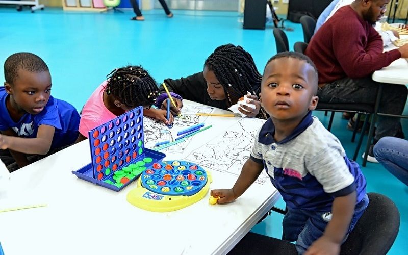 Children from the church colouring and playing games around a table